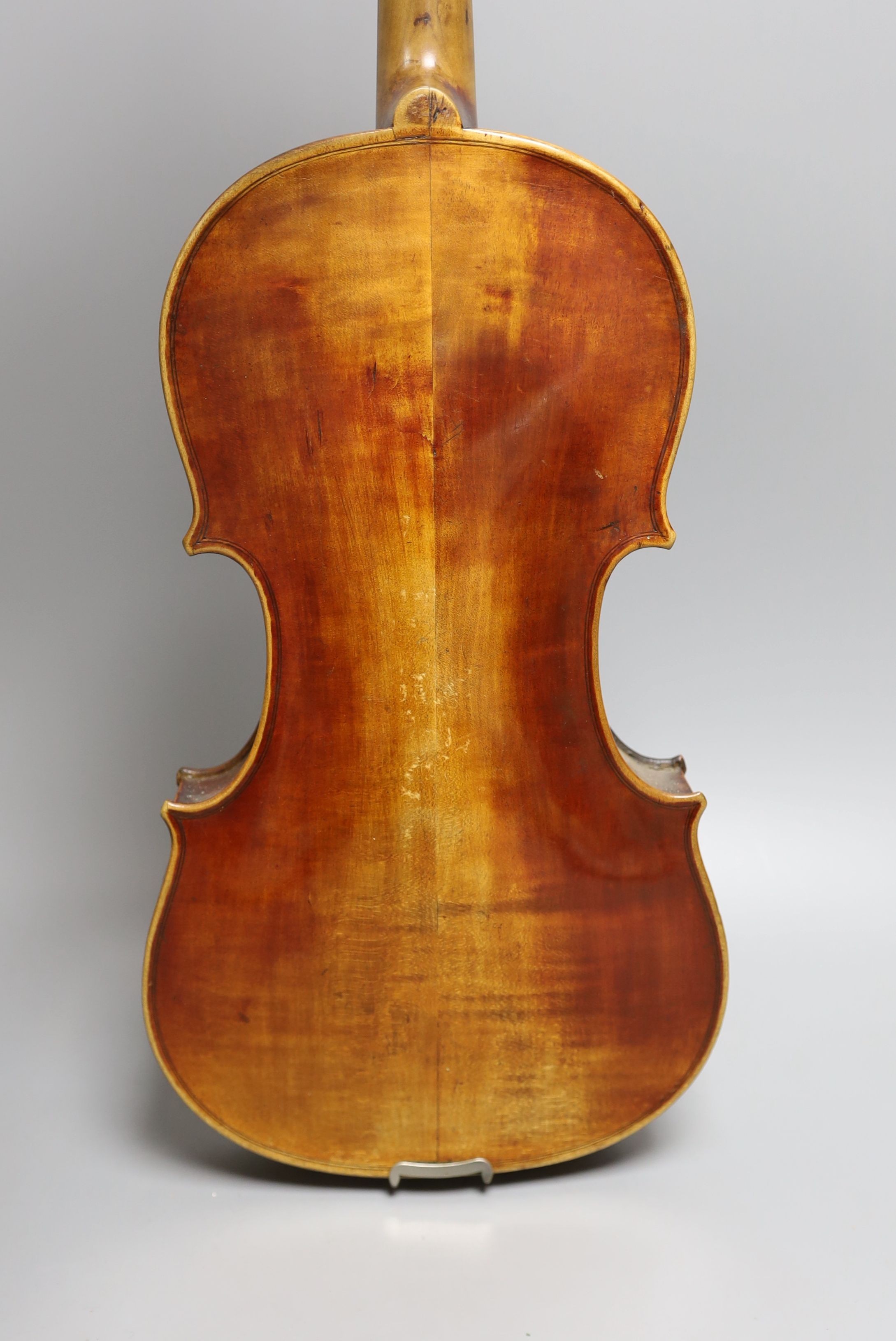 A 19th century violin with 14 inch 2 piece back, unlabelled, cased with silver mounted bow.